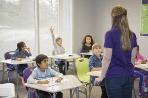 Enrichment Academy Class Teacher and Students Raised Hand Answer Learning