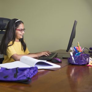 Student taking online tutoring classes on computer