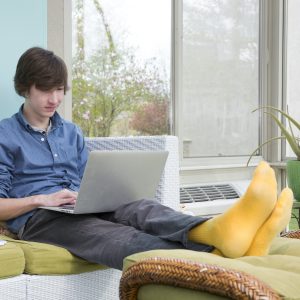 Relaxed student on computer taking online classes