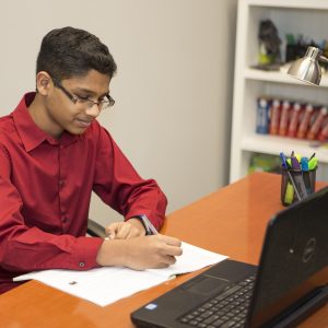 Student at desk working on homework