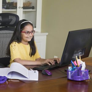 Smiling student taking tutoring classes on computer